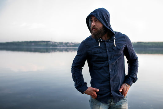 man on the beach wearing hoodie