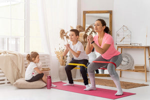 a small family mom and kids doing fitness stretching at home
