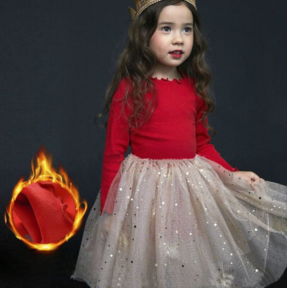 Toddler wearing a festive Christmas dress at a holiday party, from Eternal Gleams