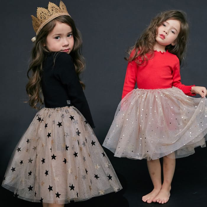 Toddler wearing a festive Christmas dress at a holiday party, from Eternal Gleams