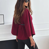 Sophisticated wine red woolen cloak with batwing sleeves, a stand collar, and an adjustable belt for a bold statement look.