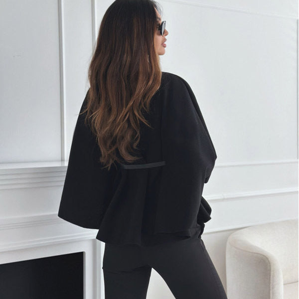 Stylish black woolen cloak for women with batwing sleeves, stand collar, and adjustable belt. Perfect outerwear for a trendy look.